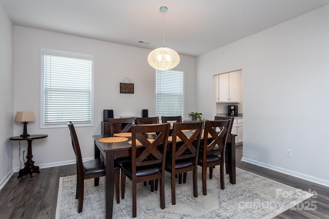 dining area with dark wood-type flooring and a wealth of natural light