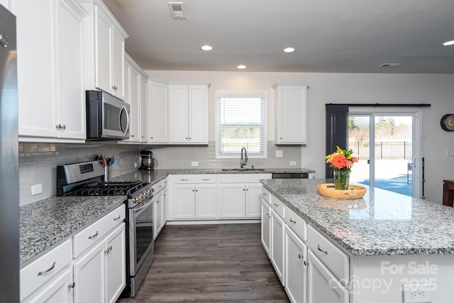 kitchen featuring white cabinets, appliances with stainless steel finishes, and a kitchen island