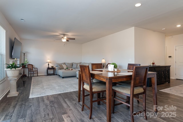 dining area featuring ceiling fan and dark hardwood / wood-style flooring