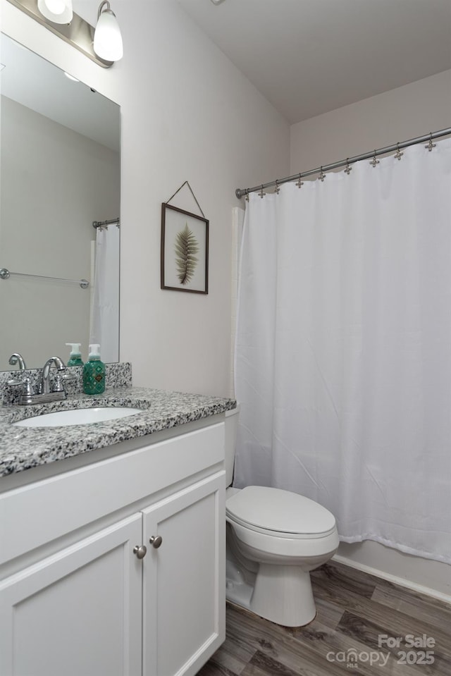 full bathroom featuring hardwood / wood-style floors, toilet, vanity, and shower / bath combination with curtain