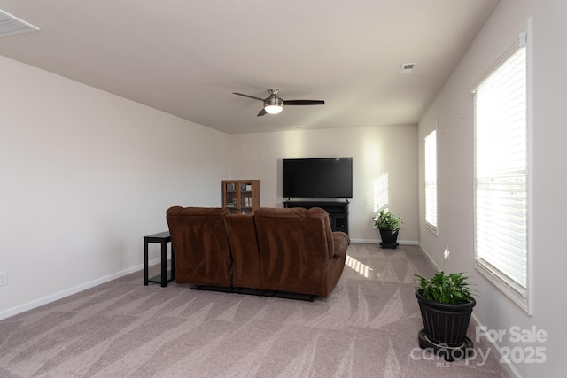 carpeted living room featuring ceiling fan