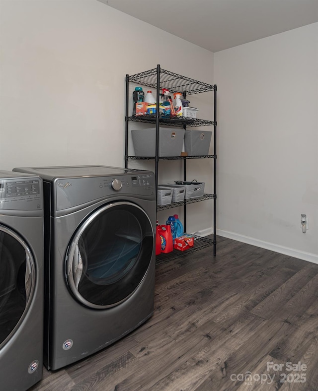 washroom featuring washing machine and dryer and dark hardwood / wood-style floors