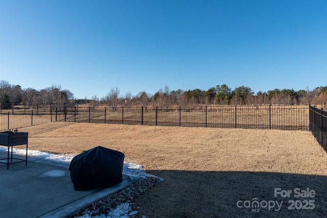 view of yard with a rural view and a patio