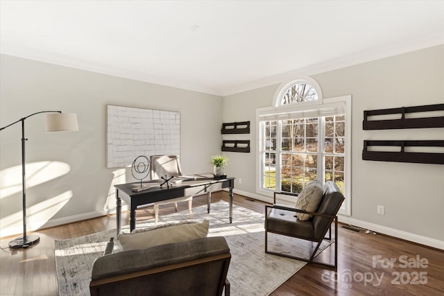 sitting room with ornamental molding and hardwood / wood-style flooring