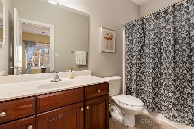 bathroom featuring toilet, tile patterned flooring, and vanity