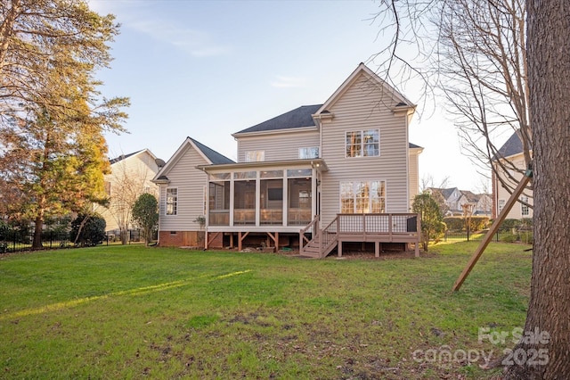 rear view of house featuring a yard, a deck, and a sunroom