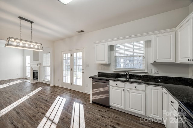 kitchen with pendant lighting, sink, stainless steel dishwasher, dark hardwood / wood-style flooring, and white cabinetry