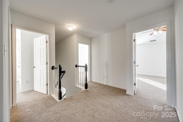 corridor with light colored carpet