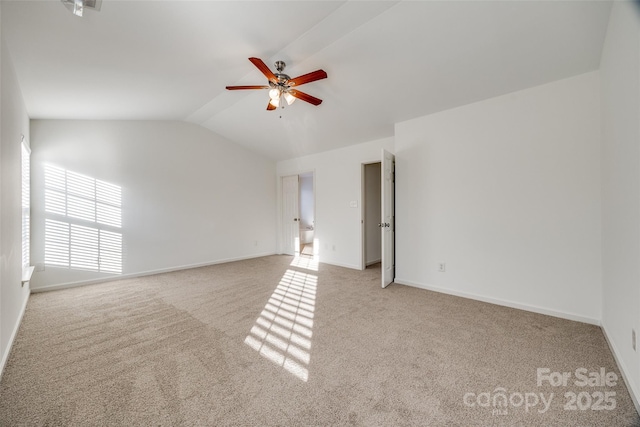 carpeted spare room with vaulted ceiling and ceiling fan