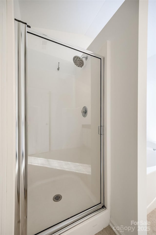 bathroom featuring a shower with door