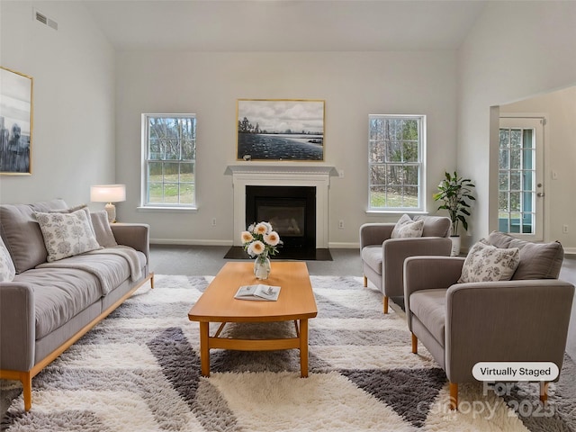 living room featuring vaulted ceiling and carpet