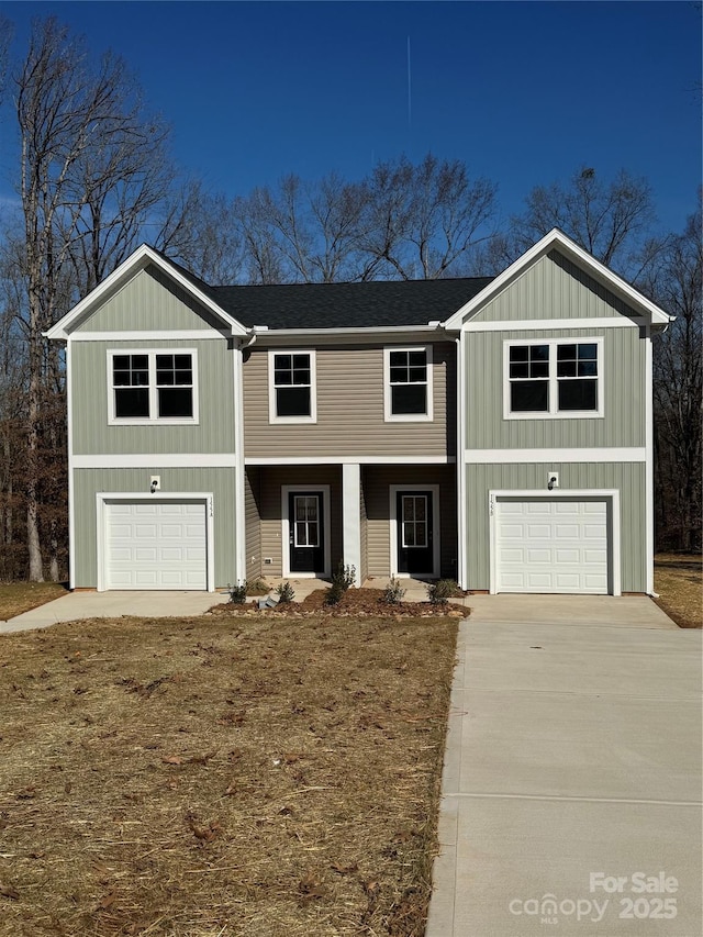 view of front of home featuring driveway, roof with shingles, and an attached garage