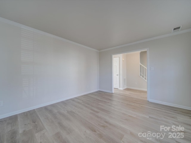 unfurnished room with crown molding and light hardwood / wood-style floors