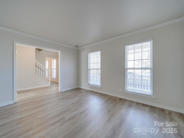 spare room featuring light hardwood / wood-style flooring and ornamental molding