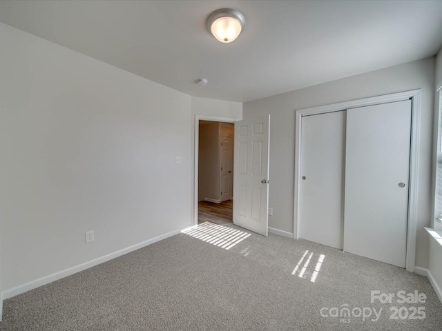 unfurnished bedroom with carpet floors and a closet