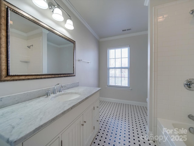 bathroom with crown molding, vanity, and tiled shower / bath