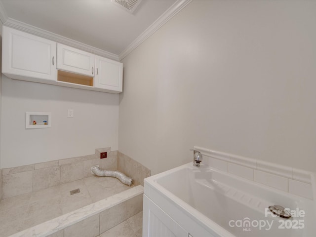 bathroom with tiled tub and ornamental molding