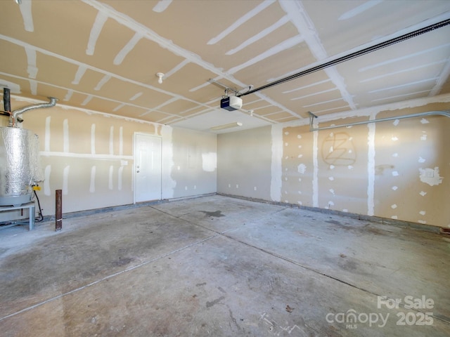 garage featuring a garage door opener and water heater