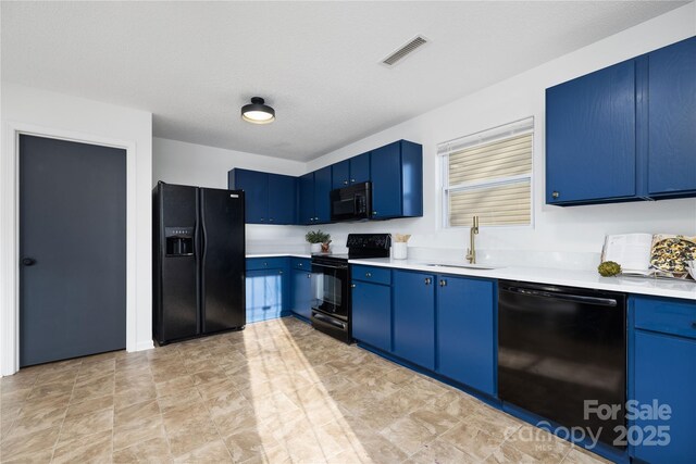 kitchen with black appliances, blue cabinetry, a textured ceiling, and sink