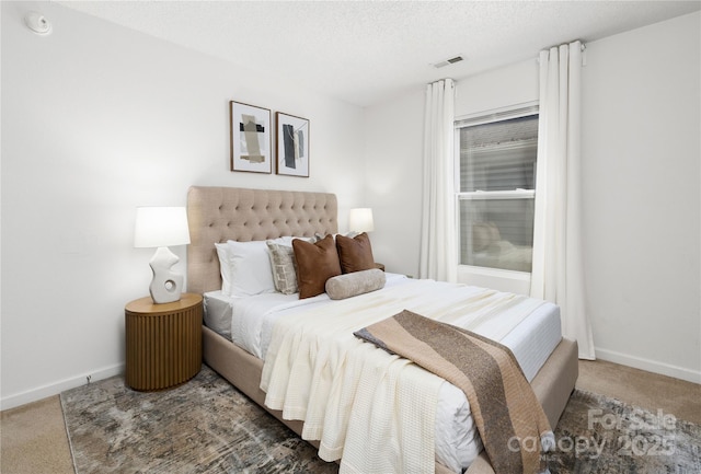 carpeted bedroom with a textured ceiling