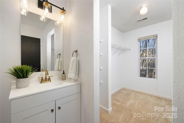 bathroom with a textured ceiling and vanity