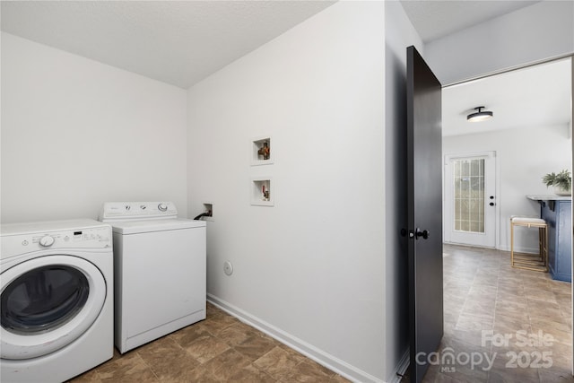 clothes washing area featuring separate washer and dryer