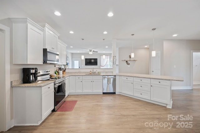 kitchen featuring stainless steel appliances, pendant lighting, white cabinets, and kitchen peninsula