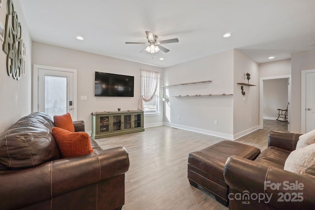 living room with hardwood / wood-style flooring and ceiling fan