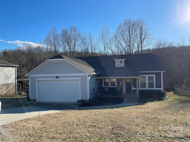 view of front of property featuring a garage, covered porch, and a front yard