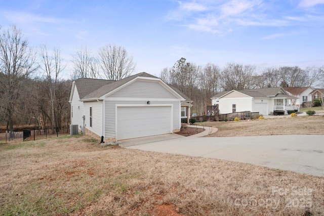 view of side of property featuring a garage and central AC