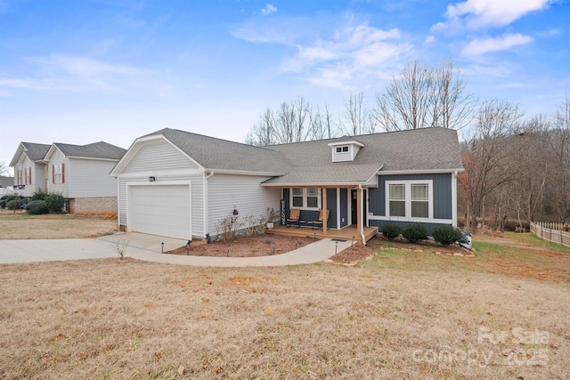 ranch-style home with a garage, a front yard, and a porch