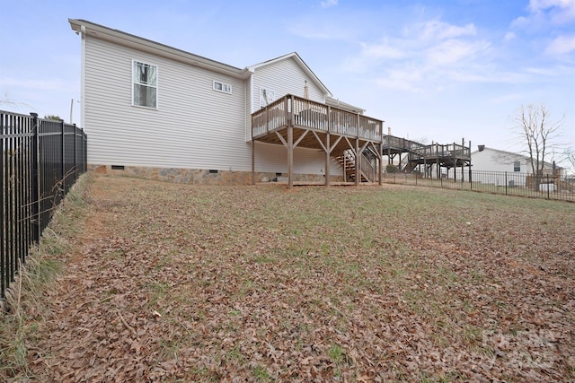 back of property featuring a wooden deck