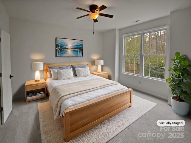 bedroom featuring light colored carpet and ceiling fan