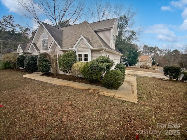 view of property exterior featuring a lawn and a garage