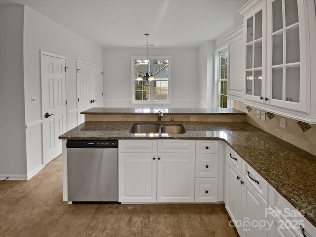 kitchen featuring white cabinets, hanging light fixtures, a notable chandelier, sink, and stainless steel dishwasher