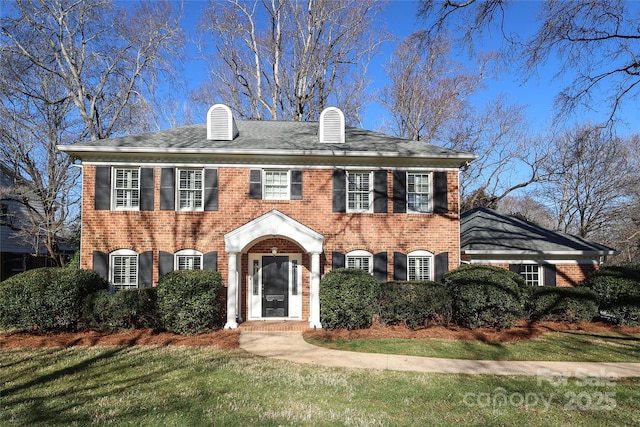 colonial inspired home with a front yard