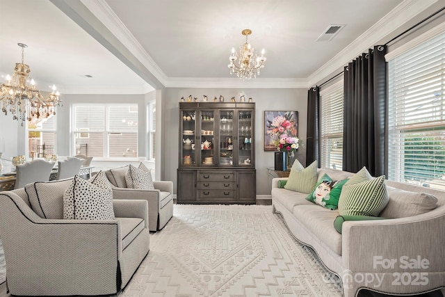 living room with a chandelier and crown molding