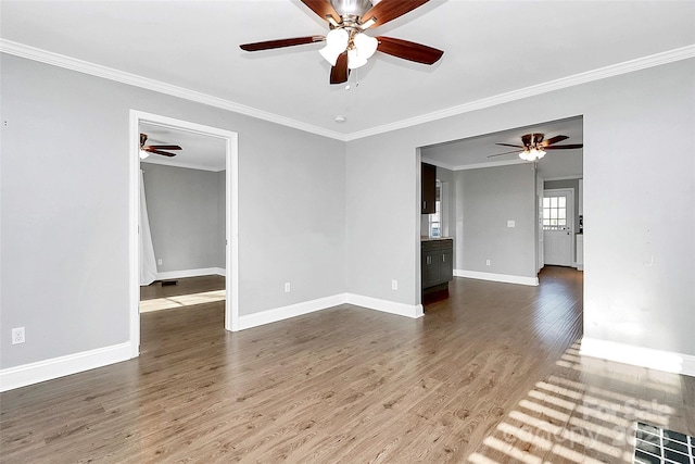 empty room with wood-type flooring and ornamental molding