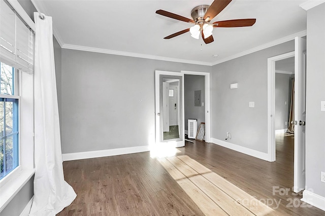 interior space with ceiling fan, electric panel, dark hardwood / wood-style flooring, and crown molding