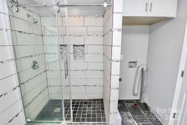 bathroom featuring a shower with shower door