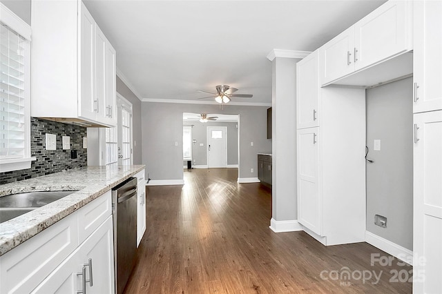 kitchen featuring light stone countertops, white cabinets, dishwasher, backsplash, and ceiling fan