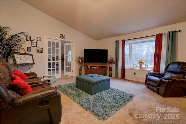 carpeted living room featuring french doors and vaulted ceiling