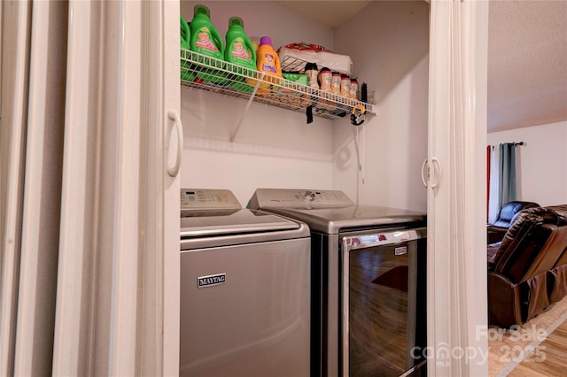 washroom with laundry area and independent washer and dryer