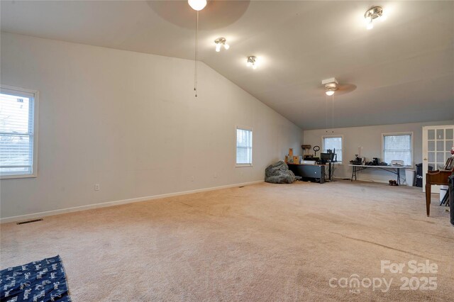 interior space with visible vents, carpet flooring, ceiling fan, high vaulted ceiling, and baseboards