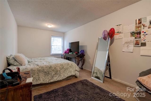 bedroom featuring a textured ceiling, baseboards, and carpet flooring