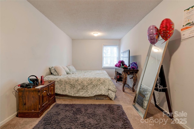 bedroom with baseboards, a textured ceiling, and light colored carpet