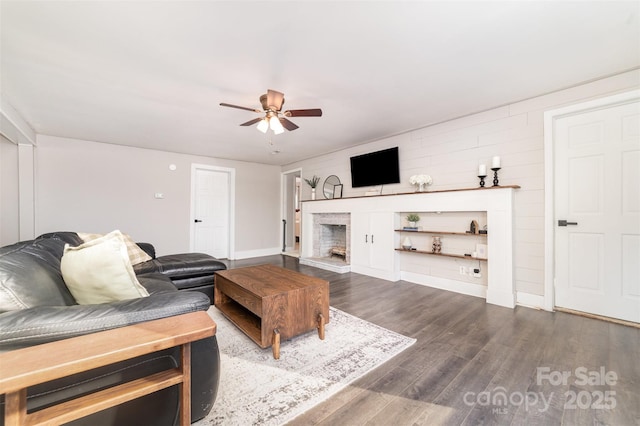 living room with ceiling fan and dark hardwood / wood-style floors