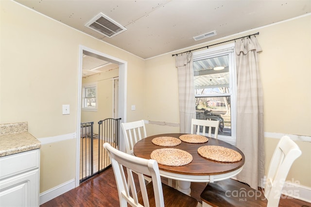 dining area with dark hardwood / wood-style floors