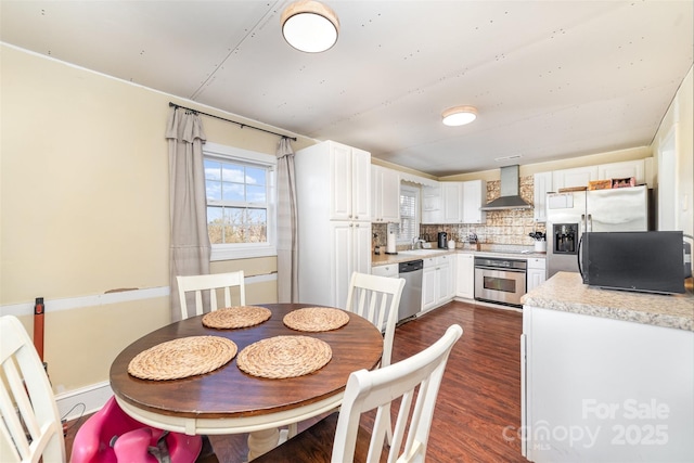 dining space featuring dark hardwood / wood-style floors and sink