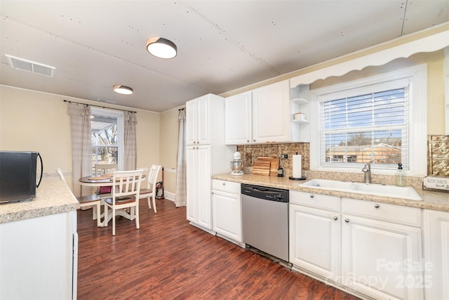 kitchen featuring tasteful backsplash, dishwasher, dark hardwood / wood-style floors, sink, and white cabinets